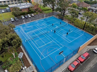 Carlson Reserve multi-purpose courts with blue synthetic surface and line markings for tennis, netball, basketball, futsal and pickleball