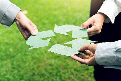 People holding recycle symbol