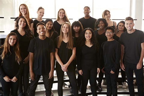 Male and female students singing