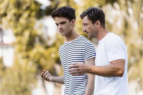 Father talking to teenage son