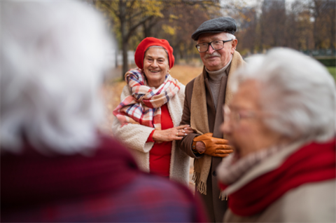 Group of happy senior friends on a walk outdoors 