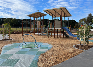 Mount Waverley Reserve playpace inclusive carousel, monkey bars, slides and play units 2024