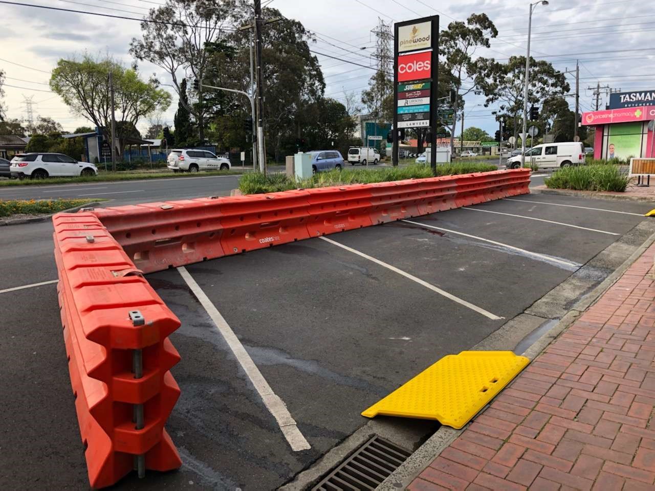 outdoor dining sections in Pinewood Village, Mount Waverley ready for reopening. Orange plastic barriers surround the expanded section of roads to be used for outdoor dining in line with COVID-19 restrictions.